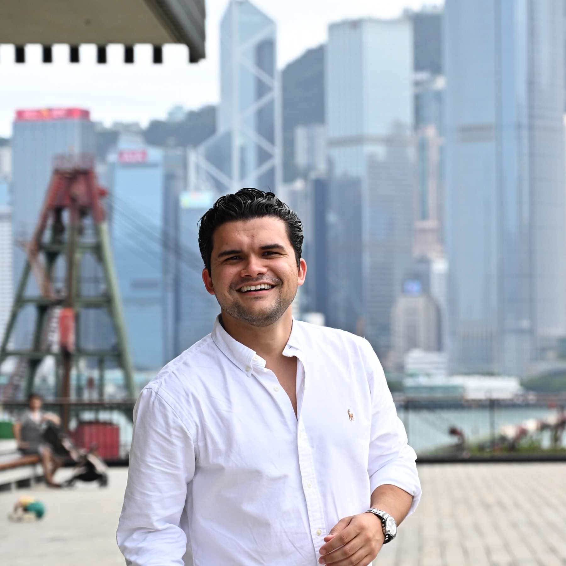 Gabriel Ramírez smiling with a city skyline in the background